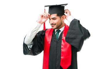 Latin young man preparing for his graduation ceremony