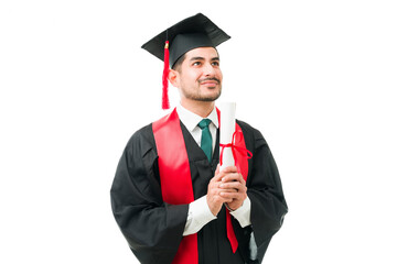 Grateful male graduate receiving his college degree