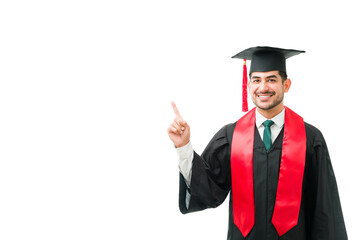 Portrait of a hispanic young man with a graduation gown