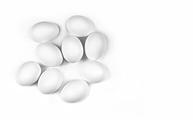 Fototapeta na wymiar Chicken white eggs on a white plate, nine pieces. Horizontal photo, flat lay. Concept - ingredients for a dish, food photography, white on white