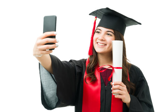 Female graduate posting a graduation photo on her social media