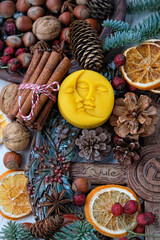 Winter altar for Yule sabbath. pagan holiday. Sun and moon symbol, wheel of the year, cinnamon, nuts, cones, dry orange slices. Witchcraft Ritual for Yuletide, Magical Winter Solstice. flat lay