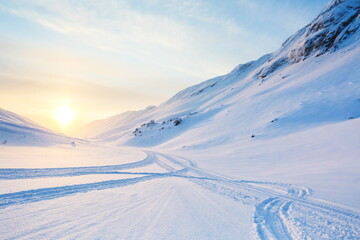 snowmobile tracks on the snow in the mountains 
