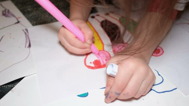 Little child girl painting drawing his family at home,kids immagination creativity in lockdown time