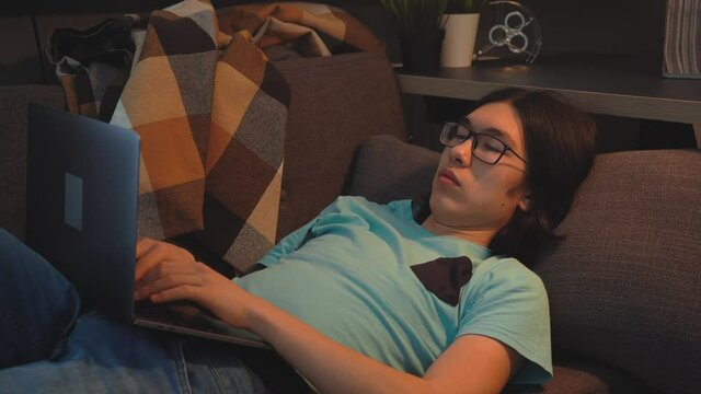 Asian Handsome  Man is Texting on Social Media on Laptop
