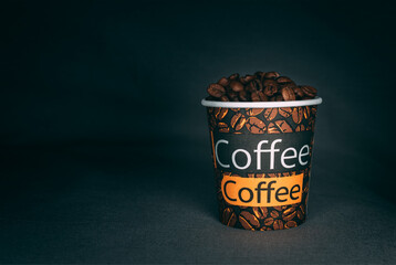 a cup of coffee beans  on black