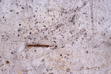grey concrete wall with sctratched areas and rusted metallic detail - textured background