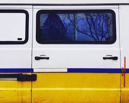 Yellow Car Against Blue Sky Seen Through Window