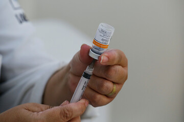 A nurse prepares a dose of the CoronaVac vaccine for COVID-19 during a priority vaccination program...