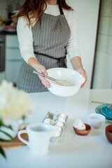Young beautiful woman bakes a cake. Sweets. Confectionery.