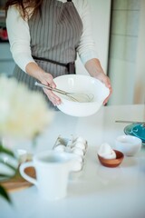 Young beautiful woman bakes a cake. Sweets. Confectionery.