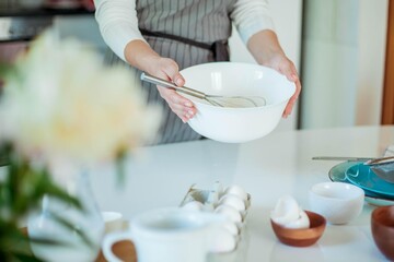Young beautiful woman bakes a cake. Sweets. Confectionery.