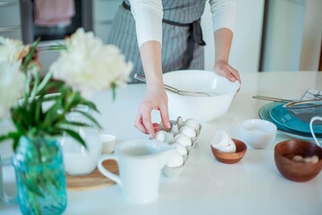 Young beautiful woman bakes a cake. Sweets. Confectionery.