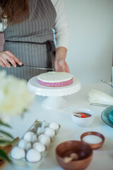 Young beautiful woman bakes a cake. Sweets. Confectionery.