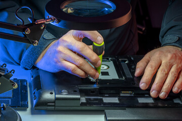 IT specialist replacing details in computer repair workshop