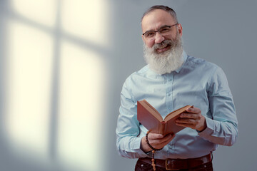 Senior charismatic man holding a book