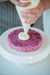 Young beautiful woman bakes a cake. Sweets. Confectionery.