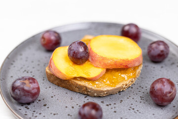 Top view of Peaches served on the plate with grapes