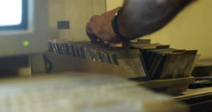 Floppy disks browsing - vintage retro 80s computer technology concept