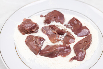 Raw Chicken Liver on the plate with flour