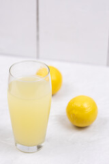 Homemade Lemonade in the glass with lemons on the table