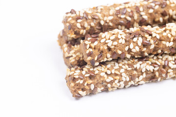 Tasty Sesame sticks closeup above white background.
