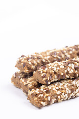 Tasty Sesame sticks closeup above white background.
