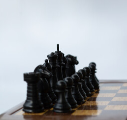 set of black chess pieces on a chess board © ResiLente