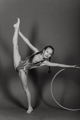 Young girl doing gymnastics over grey background