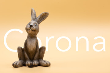 Easter bunny with green background with the inscription corona at Easter in times of covid-19 and pandemic