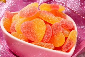 Fruit jelly in the shape of a heart on a lilac background. Sweets for the holiday. Close-up - 413374791
