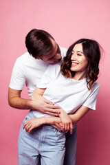young cheerful caucasian couple together having fun on pink background, guy ang girl modern relationship, lifestyle people concept