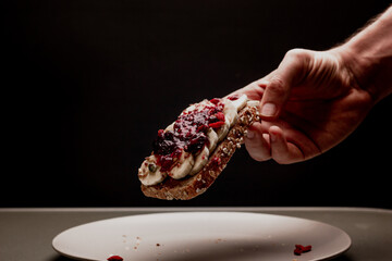 Healthy man breakfast toast with berry jam, chocolate peanut butter, banana, pumpkin, sunflower and...