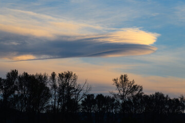 Fototapeta na wymiar Lenticular cloud at sunset looking like a spaceship announce incoming rainfall for the Snoqualmie Valley of western Washington State