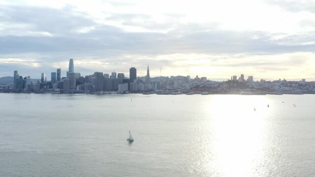 Aerial: cityscape and a bridge on the pacific ocean, drone view
