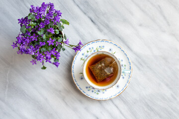 Pretty vintage floral teacup with hot tea