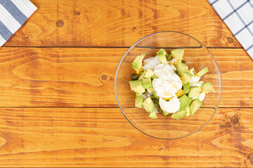 Obraz na płótnie Canvas Served Avocado salad with Eggs and Pickles