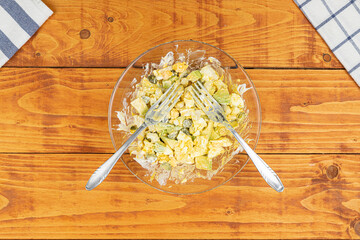 Served Avocado salad with Eggs and Pickles