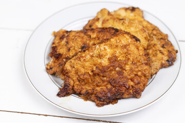 Pork meat Fried in eggs and flour served on the plate