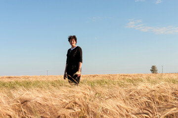 The New Agriculture: a well dressed woman stands in her barley fields.