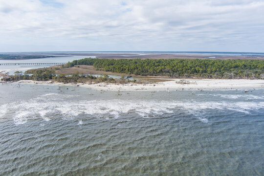 High Angle Aerial view of Hunting Island State Park with driftwood along the shore.