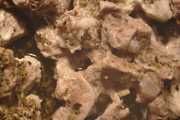 Pork slices baked in the oven. Steam is rising. Closeup