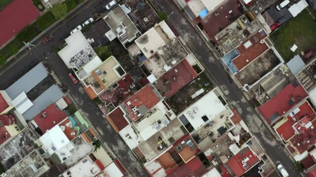 Aerial: top view houses and streets in the neighborhood, drone view