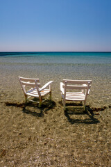 Two armchairs in the water, beach in Cesme, Izmir, Turkey.