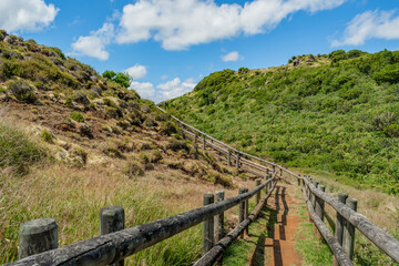 Fototapeta na wymiar Pathway with wooden fence between hills in Furnas de Enxofre, Terceira - Azores PORTUGAL