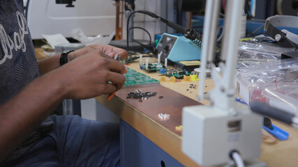 Man assembling different types of chips by hand