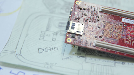 circuit board on top of a circuit diagram 