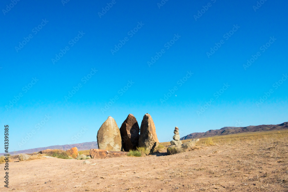 Sticker Mysterious Oshak Tas, three standing stones set by the nomads of Genghis Khan, Altyn-Emel National Park, Kazakhstan