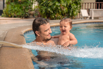Father with baby in the pool.