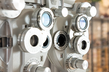 Selective focus at Optometry frame equipment. With blurred background while optometrist examine eye visual system of elder patient women with professional machine before made glasses.